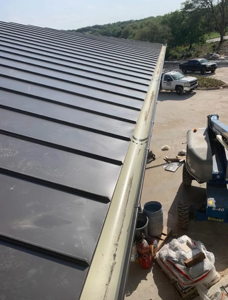 Standing seam panel and gutter detail on a metal roofing jobsite in Shady Hollow
